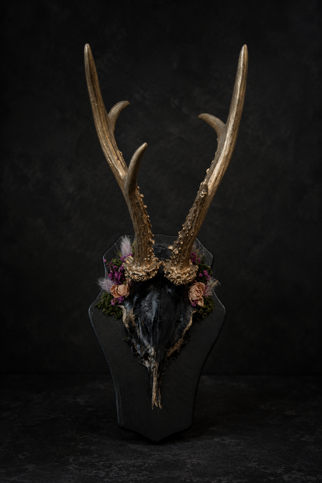 Finest Obituaries | Decorative antler skull on a black wooden plaque